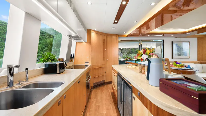 Sea Glass Yacht Photos Pics Luxurious kitchen interior on 2018 Horizon PC74 yacht with modern amenities and scenic views.