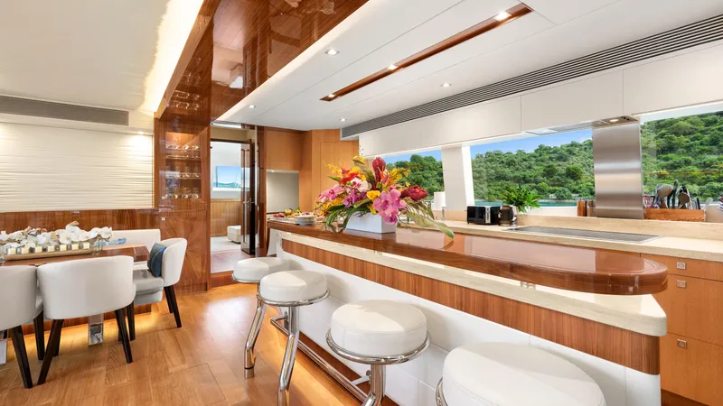 Sea Glass Yacht Photos Pics Luxurious Horizon PC74 yacht interior with elegant dining area and bar, featuring modern design.