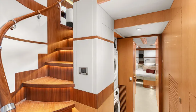 Sea Glass Yacht Photos Pics Luxurious wooden staircase and hallway inside 2018 Horizon PC74 yacht, featuring modern design elements.