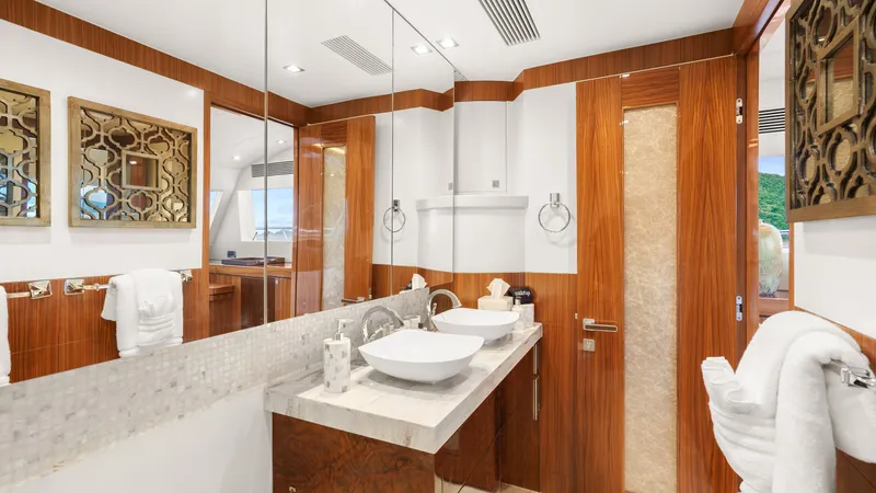 Sea Glass Yacht Photos Pics Luxurious yacht bathroom with dual sinks, elegant wood accents, and decorative mirrors, Horizon PC74 2018.