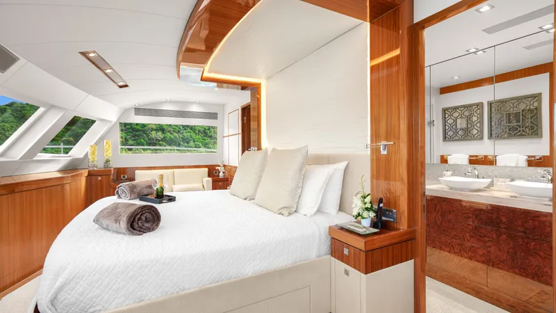 Sea Glass Yacht Photos Pics Luxurious yacht bedroom with elegant wood finishes, large windows, and modern decor. Horizon PC74, 2018.