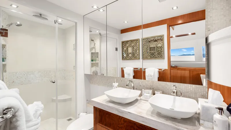 Sea Glass Yacht Photos Pics Luxurious yacht bathroom with dual sinks, glass shower, and elegant decor on Horizon PC74, 2018 model.