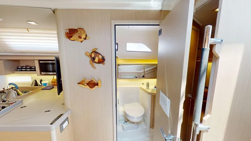 Evelyn Yacht Photos Pics Interior of 2021 Beneteau Oceanis 40.1 yacht, featuring bathroom and kitchen area.