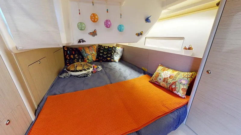 Evelyn Yacht Photos Pics Cozy cabin interior of 2021 Beneteau Oceanis 40.1 with colorful bedding and decorations.