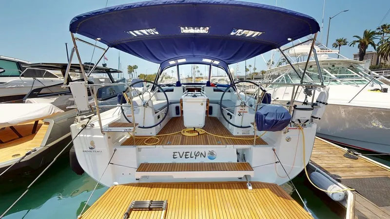 Evelyn Yacht Photos Pics 2021 Beneteau Oceanis 40.1 yacht docked, featuring spacious deck and blue canopy.