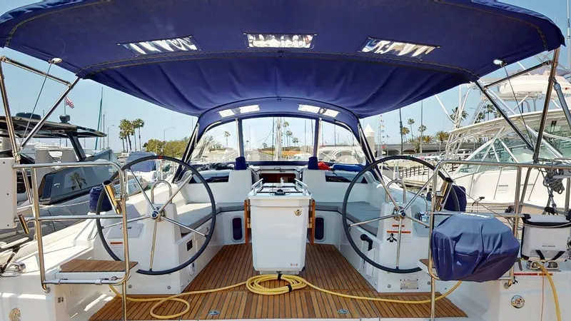 Evelyn Yacht Photos Pics Cockpit of 2021 Beneteau Oceanis 40.1 sailboat with dual steering wheels and blue canopy.