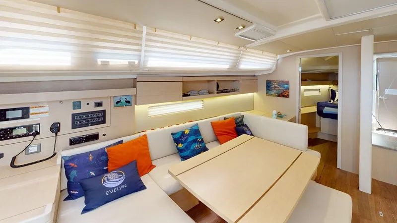 Evelyn Yacht Photos Pics Luxurious interior of 2021 Beneteau Oceanis 40.1 yacht with cozy seating and modern decor.