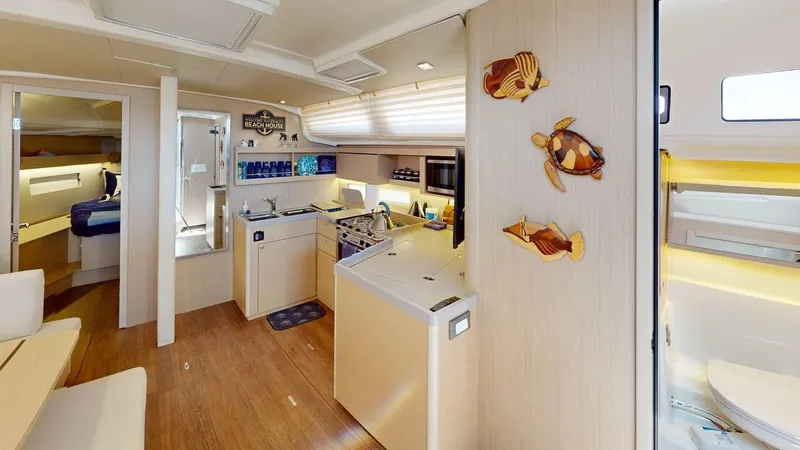 Evelyn Yacht Photos Pics 2021 Beneteau Oceanis 40.1 yacht interior with modern kitchen and nautical decor.