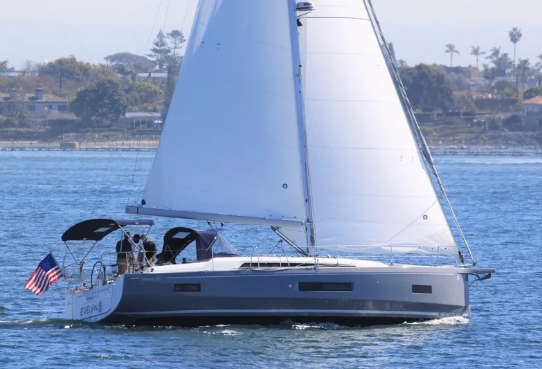 Evelyn Yacht Photos Pics 2021 Beneteau Oceanis 40.1 sailing on calm waters with American flag.