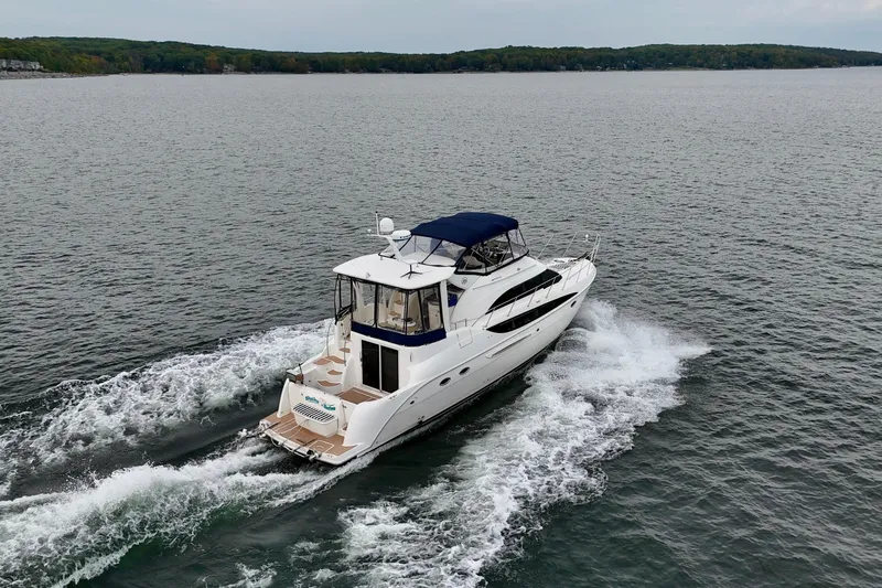 Shake N' Bake Yacht Photos Pics 2006 Meridian Motoryacht cruising on a serene lake with lush green shoreline.