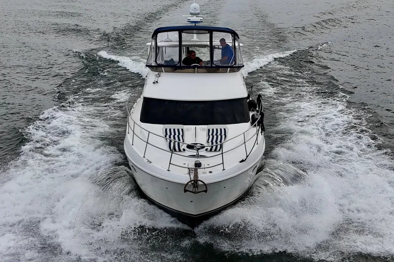 Shake N' Bake Yacht Photos Pics 2006 Meridian Motoryacht cruising on open water, creating a dynamic wake.