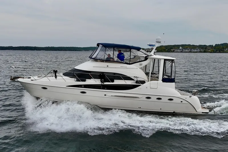 Shake N' Bake Yacht Photos Pics 2006 Meridian Motoryacht cruising on a lake with scenic shoreline in the background.