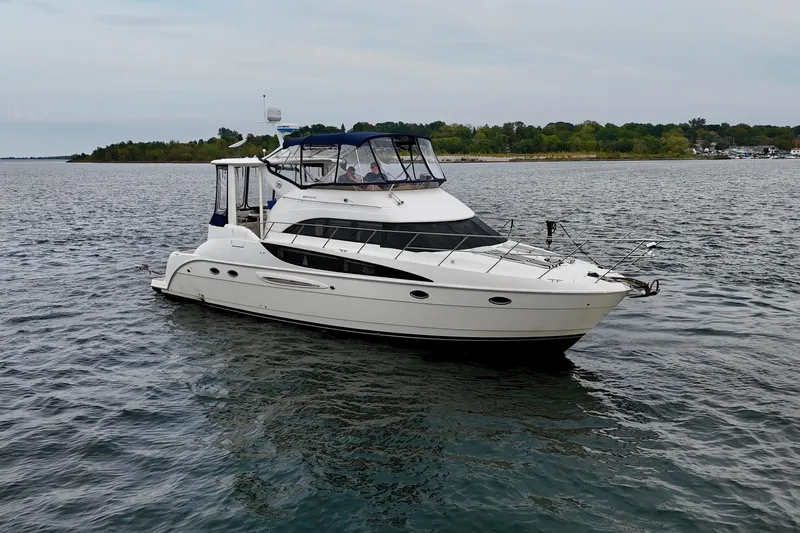 Shake N' Bake Yacht Photos Pics 2006 Meridian Motoryacht cruising on a calm lake with lush green shoreline.