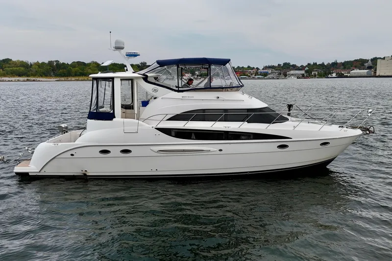 Shake N' Bake Yacht Photos Pics 2006 Meridian Motoryacht on calm water, featuring sleek design and spacious deck.