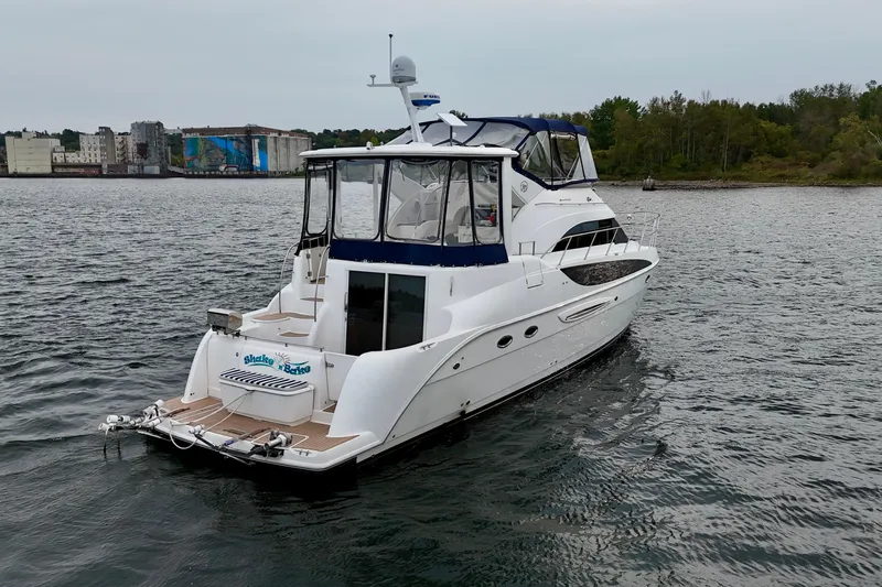 Shake N' Bake Yacht Photos Pics 2006 Meridian Motoryacht on water, cityscape and trees in background.