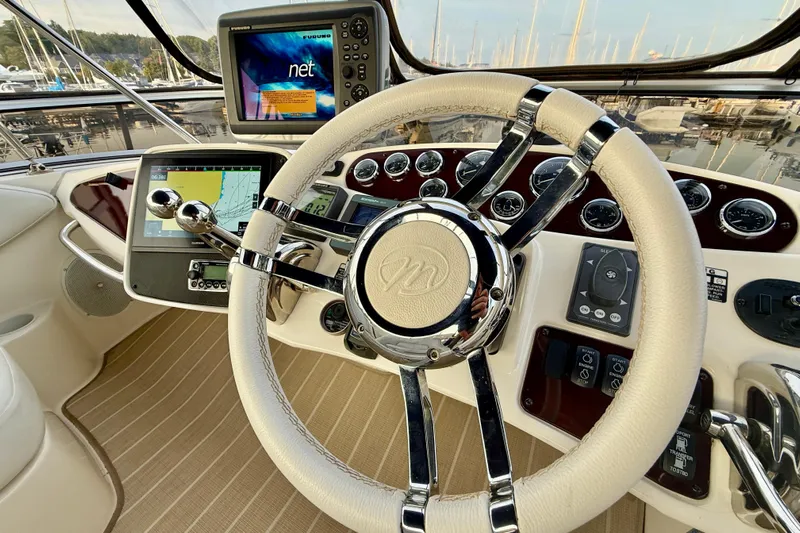 Shake N' Bake Yacht Photos Pics Steering wheel and dashboard of a 2006 Meridian Motoryacht with navigation screens.