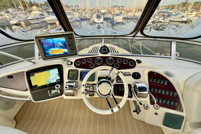 Shake N' Bake Yacht Photos Pics Cockpit of a 2006 Meridian Motoryacht with navigation equipment and steering wheel.