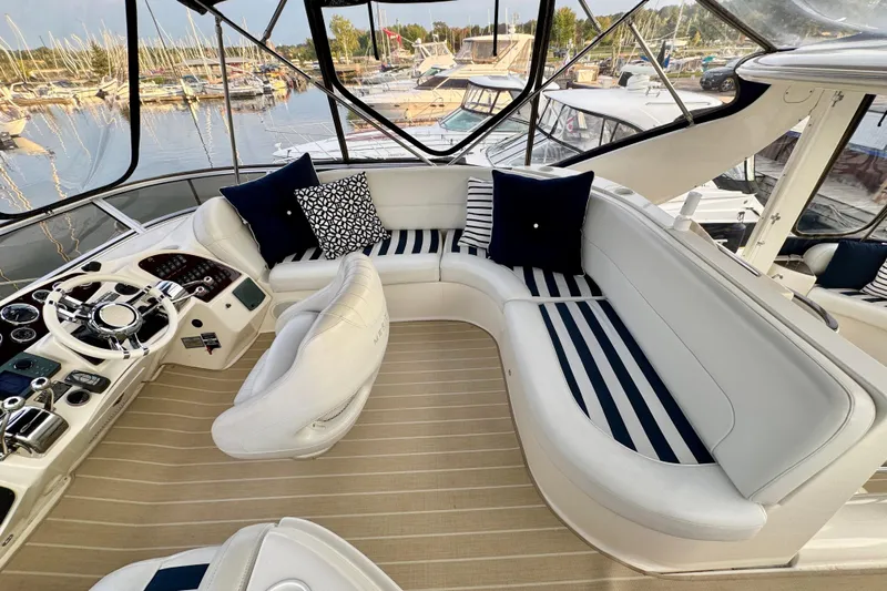 Shake N' Bake Yacht Photos Pics Luxurious 2006 Meridian Motoryacht interior with plush seating and elegant helm, docked at marina.