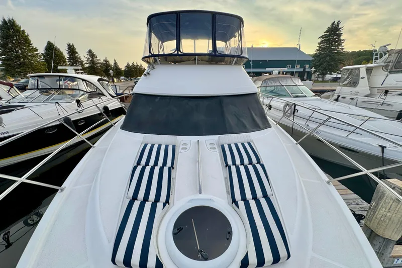 Shake N' Bake Yacht Photos Pics 2006 Meridian Motoryacht with striped deck cushions docked at marina during sunset.