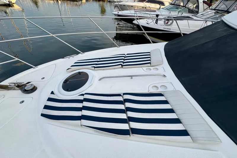 Shake N' Bake Yacht Photos Pics 2006 Meridian Motoryacht with striped cushions on deck, docked at marina.