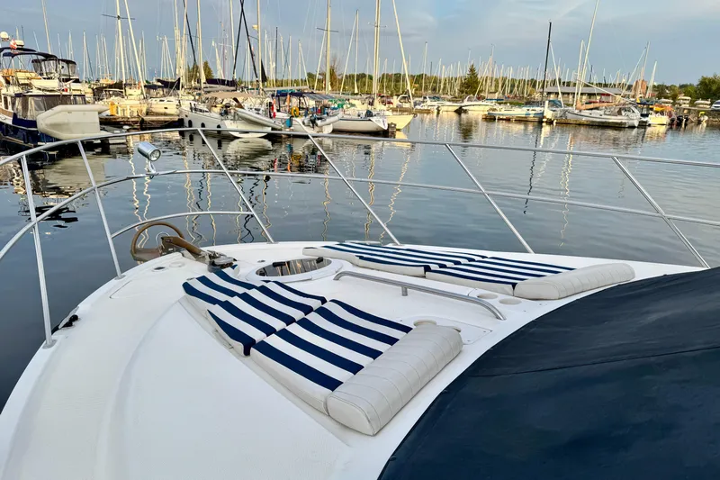 Shake N' Bake Yacht Photos Pics 2006 Meridian Motoryacht with striped sun loungers docked in a marina.
