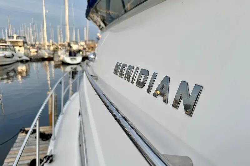 Shake N' Bake Yacht Photos Pics 2006 Meridian Motoryacht docked in marina, showcasing sleek design and branding.