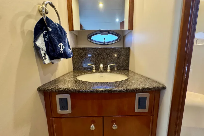 Shake N' Bake Yacht Photos Pics Luxurious 2006 Meridian Motoryacht bathroom with granite countertop and nautical-themed towel.