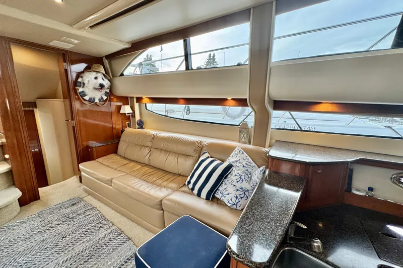 Shake N' Bake Yacht Photos Pics Luxurious 2006 Meridian Motoryacht interior with leather sofa, nautical decor, and large windows.