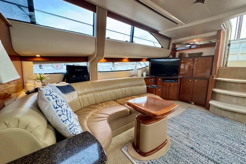 Shake N' Bake Yacht Photos Pics Luxurious 2006 Meridian Motoryacht interior with plush seating, TV, and elegant wood finishes.