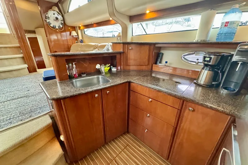 Shake N' Bake Yacht Photos Pics Luxurious 2006 Meridian Motoryacht interior with elegant wood cabinetry and modern kitchen amenities.