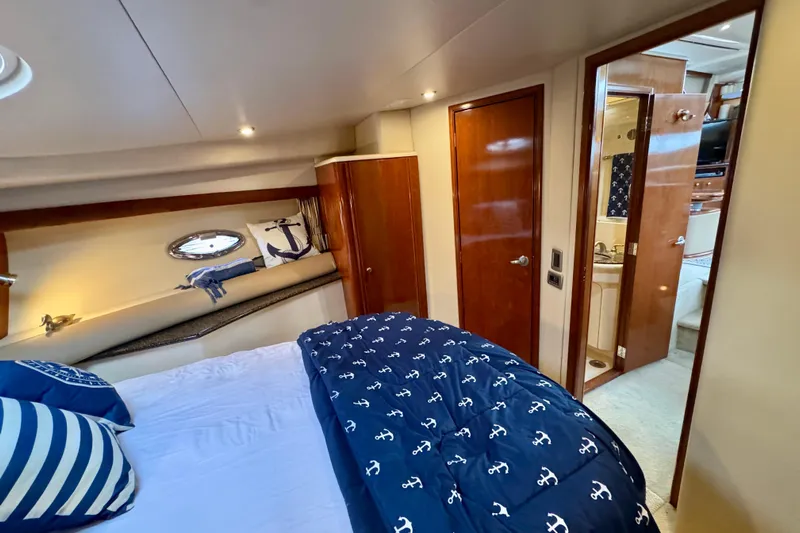 Shake N' Bake Yacht Photos Pics Luxurious 2006 Meridian Motoryacht bedroom with nautical-themed decor and ensuite bathroom.