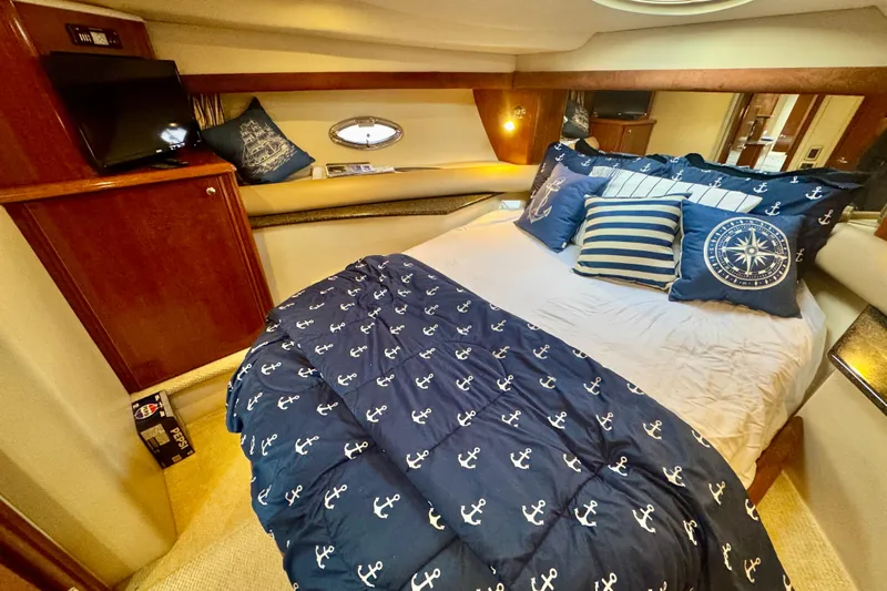 Shake N' Bake Yacht Photos Pics Luxurious 2006 Meridian Motoryacht bedroom with nautical-themed bedding and cozy decor.