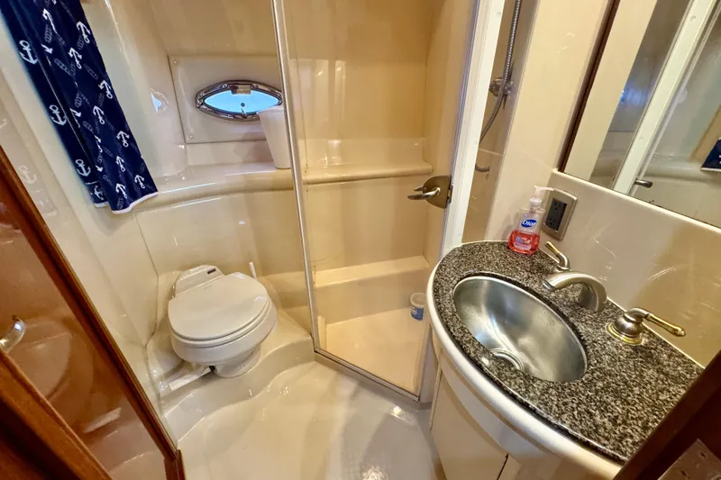 Shake N' Bake Yacht Photos Pics Luxurious 2006 Meridian Motoryacht bathroom with shower, toilet, and granite sink.