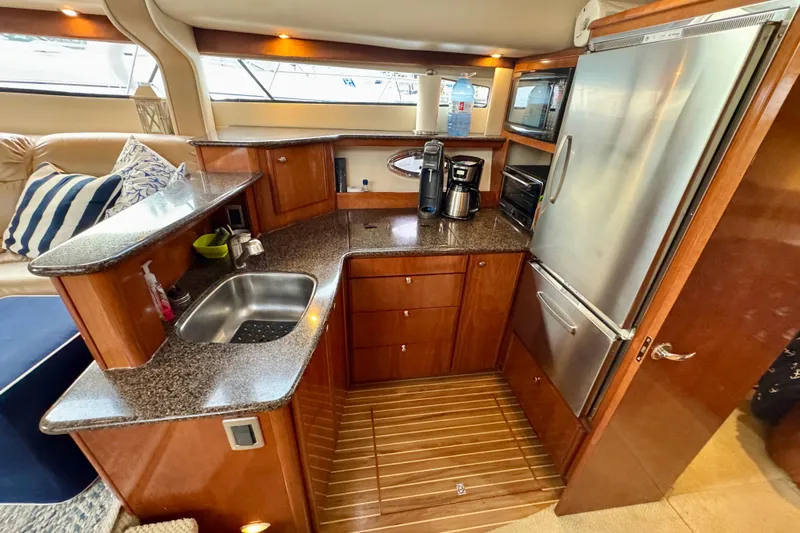 Shake N' Bake Yacht Photos Pics Luxurious 2006 Meridian Motoryacht kitchen with modern appliances and elegant wood cabinetry.
