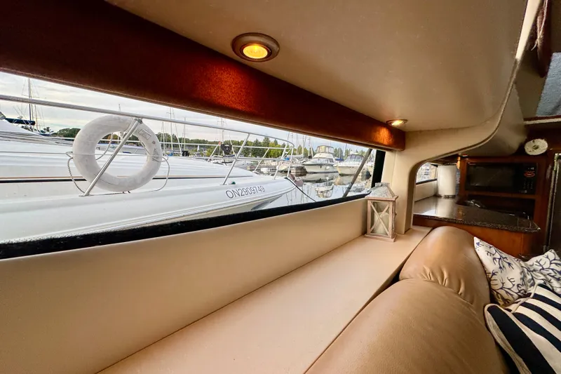 Shake N' Bake Yacht Photos Pics Interior view of 2006 Meridian Motoryacht with cozy seating and marina view.