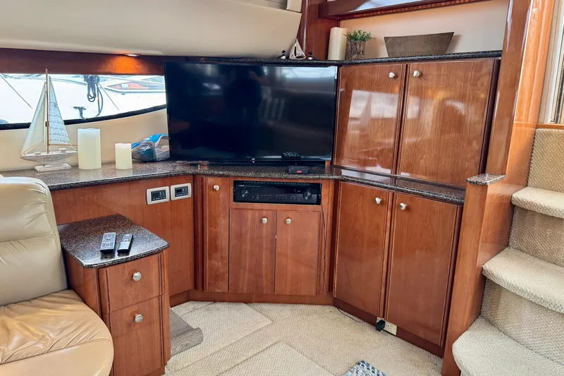 Shake N' Bake Yacht Photos Pics Luxurious 2006 Meridian Motoryacht interior with TV, wooden cabinetry, and elegant decor.