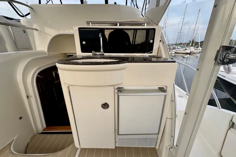 Shake N' Bake Yacht Photos Pics 2006 Meridian Motoryacht interior with kitchenette, featuring sink and mini fridge, docked at marina.