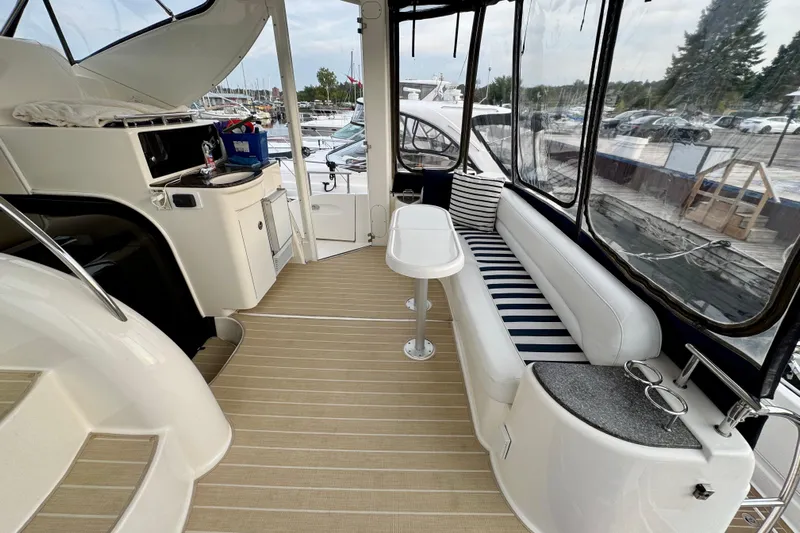 Shake N' Bake Yacht Photos Pics 2006 Meridian Motoryacht interior with striped seating, kitchenette, and panoramic windows.