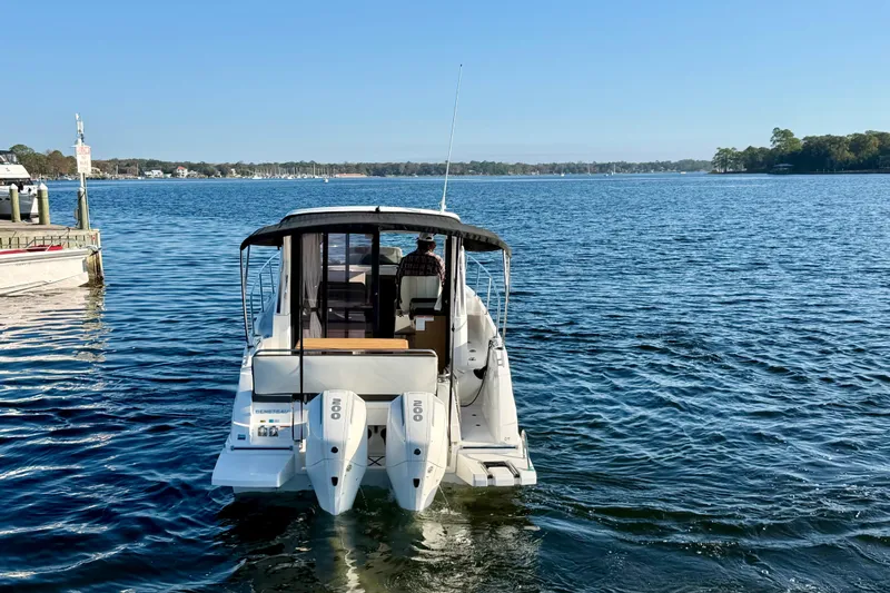  Yacht Photos Pics 2021 Beneteau Antares 9 boat on calm water, rear view with dual engines.