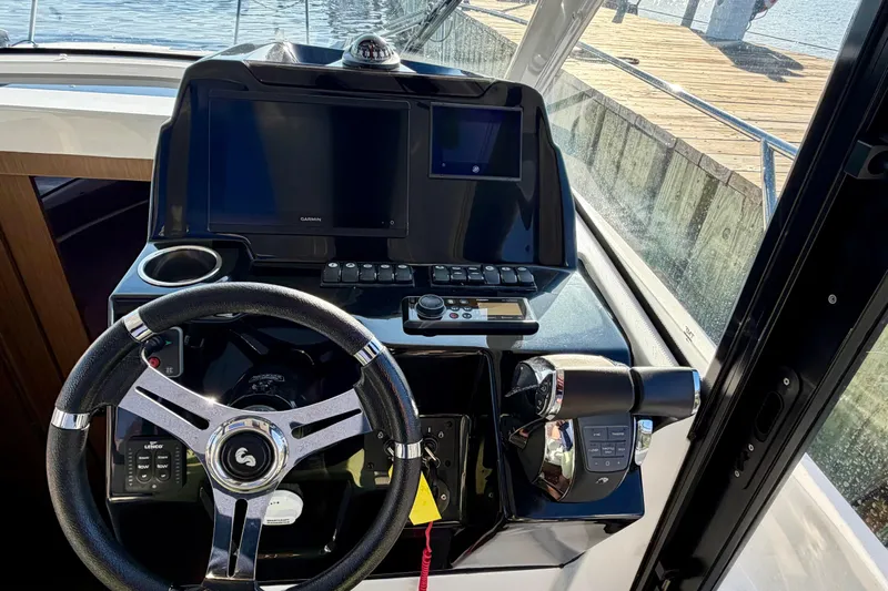  Yacht Photos Pics Helm of 2021 Beneteau Antares 9 with steering wheel and navigation screens.