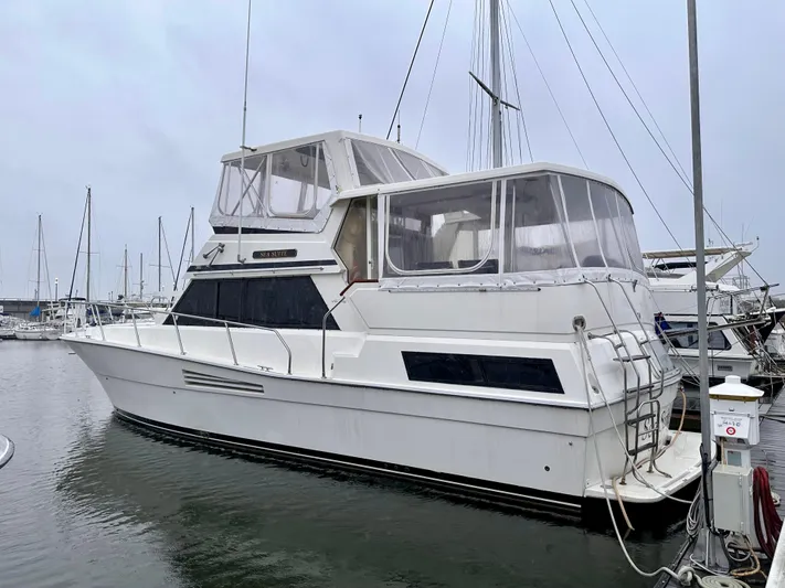 Sea Suite Yacht Photos Pics 1989 Viking 44 Motor Yacht docked in marina, featuring spacious cabin and sleek design.
