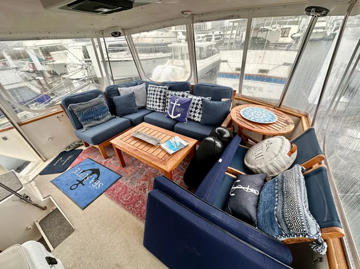 Sea Suite Yacht Photos Pics 1989 Viking 44 Motor Yacht interior with blue seating, nautical decor, and marina view.