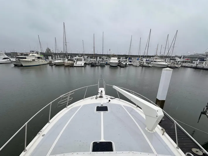 Sea Suite Yacht Photos Pics Bow view of 1989 Viking 44 Motor Yacht docked in a marina.