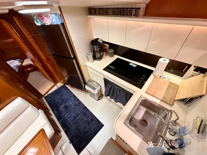 Sea Suite Yacht Photos Pics 1989 Viking 44 Motor Yacht kitchen with modern appliances and wooden cabinetry.