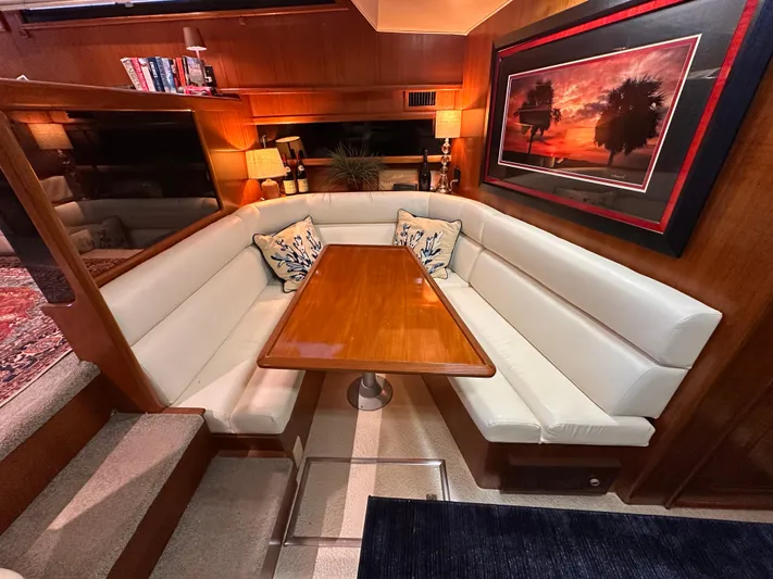 Sea Suite Yacht Photos Pics Luxurious interior of 1989 Viking 44 Motor Yacht with elegant dining area and sunset artwork.