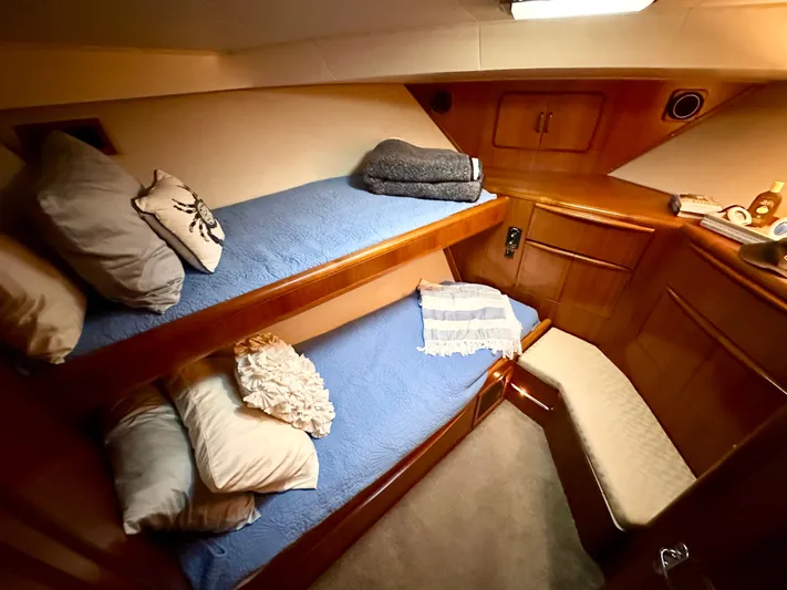 Sea Suite Yacht Photos Pics Cozy cabin interior of 1989 Viking 44 Motor Yacht with bunk beds and wooden finish.