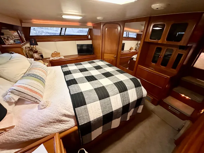 Sea Suite Yacht Photos Pics 1989 Viking 44 Motor Yacht bedroom with checkered bedding and wooden cabinetry.