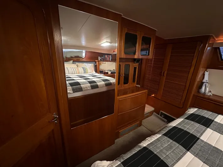 Sea Suite Yacht Photos Pics 1989 Viking 44 Motor Yacht cabin with wood paneling and plaid bedding.