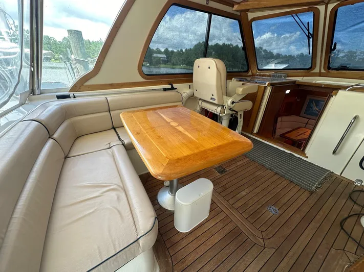 True Blue Yacht Photos Pics Interior of 2005 Sabre 42 Express yacht with wooden table and leather seating.
