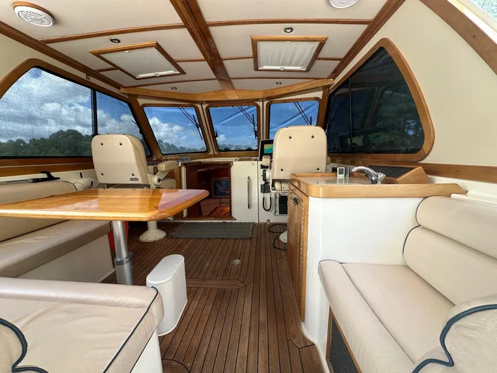 True Blue Yacht Photos Pics Interior of 2005 Sabre 42 Express yacht with wood accents and plush seating.